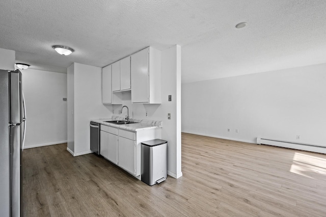 4101 Parklawn Ave Unit 320, Edina, MN 55435 - kitchen featuring stainless steel appliances, a textured ceiling, light wood-type flooring, light countertops, and baseboard heating