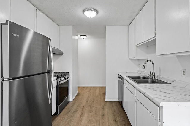 4101 Parklawn Ave Unit 320, Edina, MN 55435 - kitchen with stainless steel appliances, under cabinet range hood, light countertops, light wood-style floors, and white cabinetry
