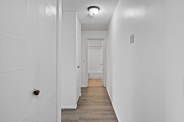 4101 Parklawn Ave Unit 320, Edina, MN 55435 - hallway featuring light wood-style flooring and a textured ceiling