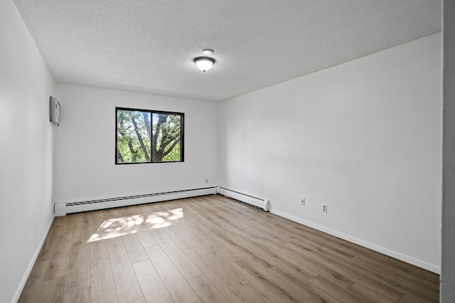 4101 Parklawn Ave Unit 320, Edina, MN 55435 - spare room with wood finished floors, a textured ceiling, and a baseboard radiator