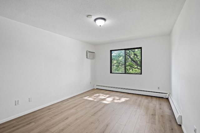 4101 Parklawn Ave Unit 320, Edina, MN 55435 - unfurnished room with an AC wall unit, baseboard heating, wood finished floors, and a textured ceiling