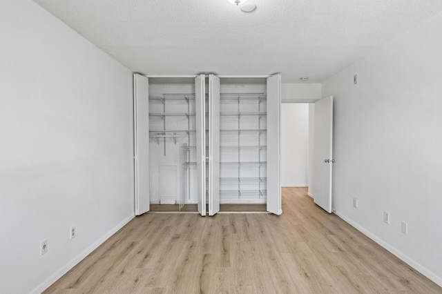4101 Parklawn Ave Unit 320, Edina, MN 55435 - unfurnished bedroom with wood finished floors and a textured ceiling