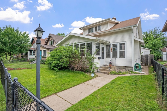 3734 Emerson Ave N, Minneapolis, MN 55412 - view of front of house with a fenced backyard, a chimney, and a sunroom