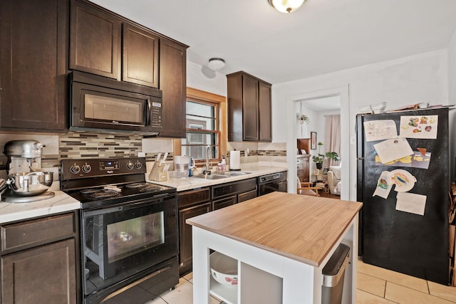 3734 Emerson Ave N, Minneapolis, MN 55412 - kitchen featuring black appliances, light tile patterned floors, dark brown cabinetry, and tasteful backsplash