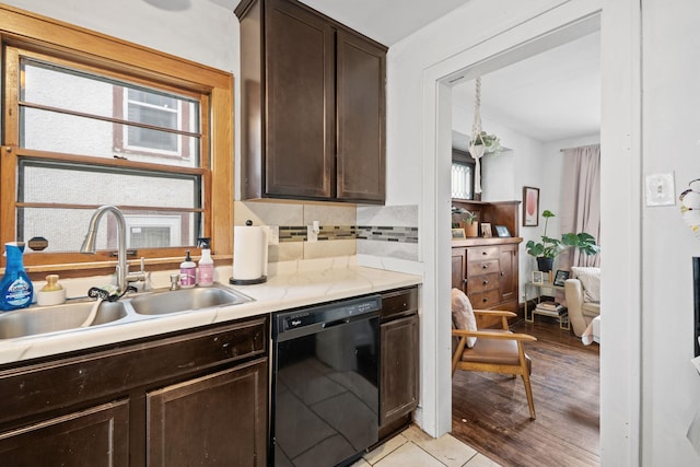 3734 Emerson Ave N, Minneapolis, MN 55412 - kitchen featuring dishwasher, dark brown cabinets, light countertops, backsplash, and light wood-type flooring
