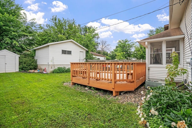 3734 Emerson Ave N, Minneapolis, MN 55412 - wooden deck featuring a yard, a storage unit, and a sunroom