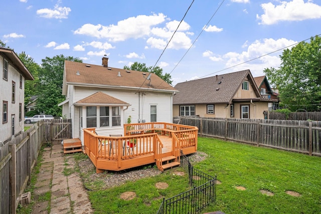 3734 Emerson Ave N, Minneapolis, MN 55412 - rear view of house with a fenced backyard, a wooden deck, and a chimney