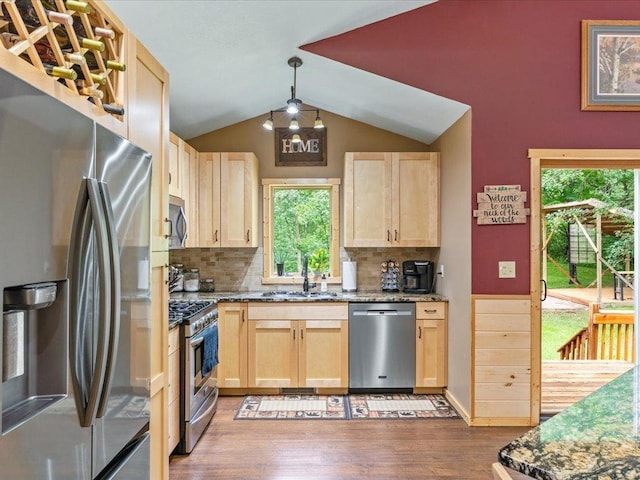 31591 Summer Dr, Breezy Point, MN 56472 - kitchen featuring stainless steel appliances, light brown cabinets, wood finished floors, healthy amount of natural light, and vaulted ceiling