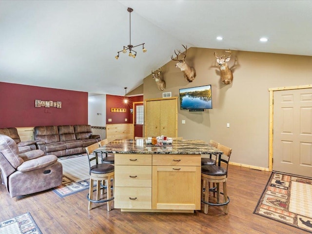 31591 Summer Dr, Breezy Point, MN 56472 - kitchen featuring a breakfast bar, light brown cabinetry, dark wood-type flooring, high vaulted ceiling, and recessed lighting