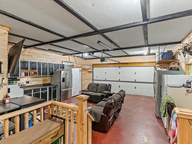 31591 Summer Dr, Breezy Point, MN 56472 - garage with high quality fridge, a garage door opener, wood walls, and freestanding refrigerator
