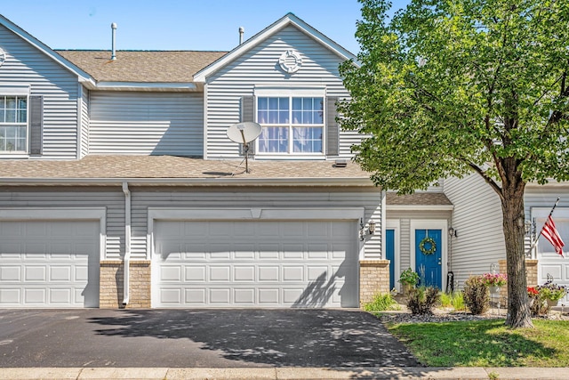 1343 Yorkshire Ln, Shakopee, MN 55379 - view of front of house featuring driveway, roof with shingles, and a garage