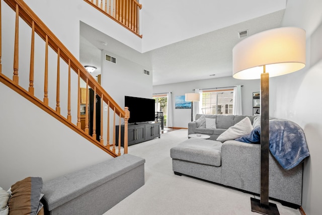 1343 Yorkshire Ln, Shakopee, MN 55379 - living area with carpet, stairway, and a towering ceiling