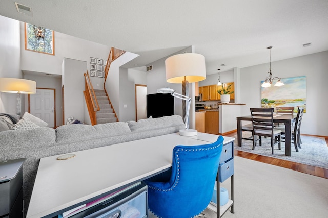 1343 Yorkshire Ln, Shakopee, MN 55379 - living area featuring a chandelier, stairs, light wood-style flooring, and light colored carpet