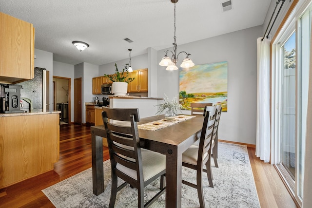 1343 Yorkshire Ln, Shakopee, MN 55379 - dining space with light wood finished floors and a chandelier