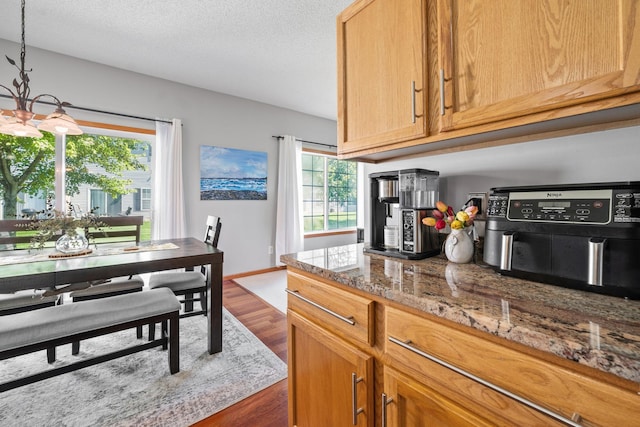 1343 Yorkshire Ln, Shakopee, MN 55379 - kitchen featuring dark wood-style floors, a chandelier, and a textured ceiling