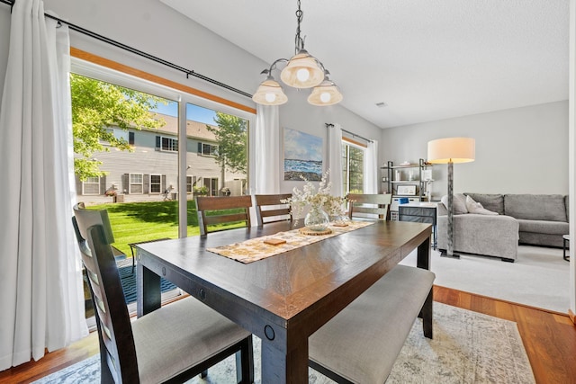 1343 Yorkshire Ln, Shakopee, MN 55379 - dining area with healthy amount of natural light, wood finished floors, and a chandelier