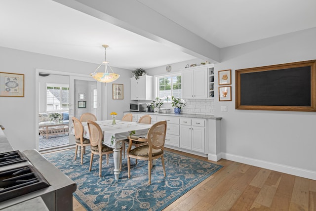6920 Russell Ave S, Richfield, MN 55423 - dining space featuring light wood finished floors and beamed ceiling