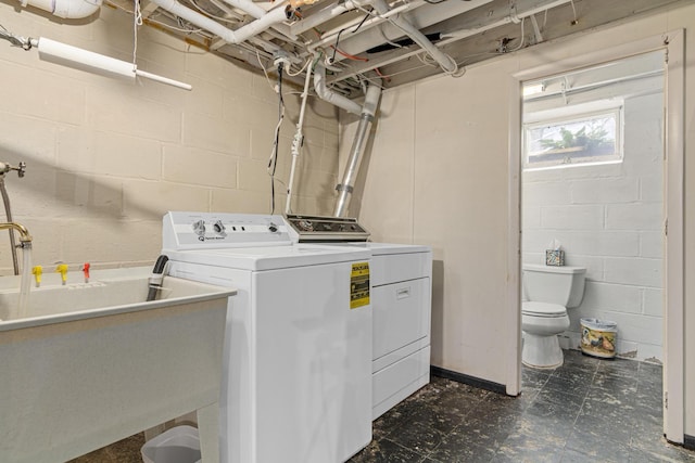 6920 Russell Ave S, Richfield, MN 55423 - laundry area featuring separate washer and dryer, dark flooring, and concrete block wall