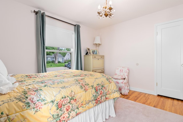 6920 Russell Ave S, Richfield, MN 55423 - bedroom featuring wood finished floors and a chandelier