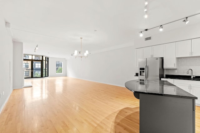 408 1st St Unit 310, Minneapolis, MN 55401 - kitchen featuring stainless steel fridge with ice dispenser, open floor plan, and light wood-style flooring