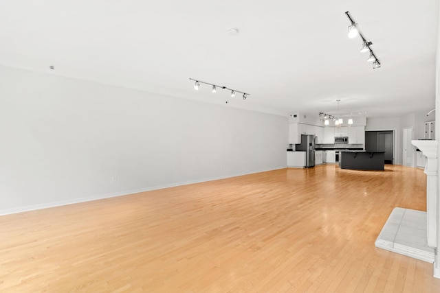 408 1st St Unit 310, Minneapolis, MN 55401 - unfurnished living room with track lighting, light wood-type flooring, and a chandelier