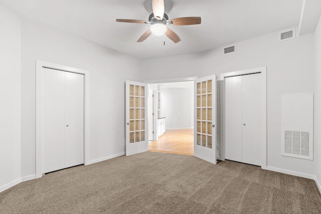 408 1st St Unit 310, Minneapolis, MN 55401 - unfurnished bedroom with carpet flooring, ceiling fan, french doors, and multiple closets