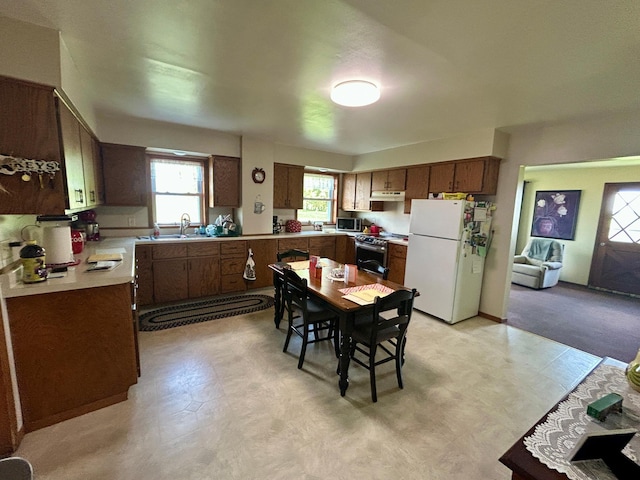 31231 568th Ave, Deer Creek Twp, MN 56527 - kitchen featuring appliances with stainless steel finishes, light flooring, light countertops, and brown cabinetry