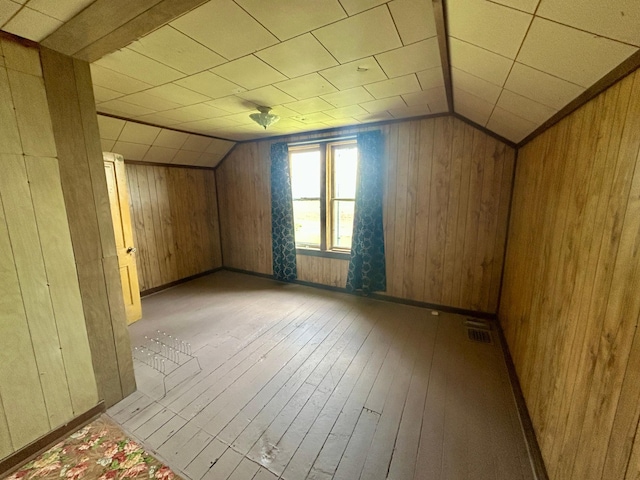 31231 568th Ave, Deer Creek Twp, MN 56527 - additional living space featuring hardwood / wood-style flooring, vaulted ceiling, and wooden walls