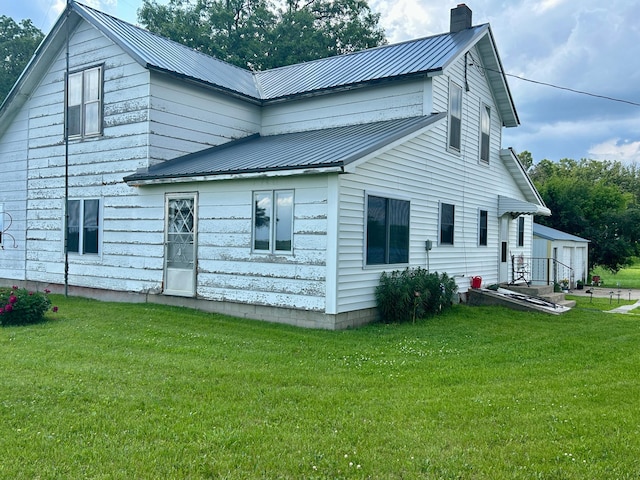 31231 568th Ave, Deer Creek Twp, MN 56527 - back of property featuring a lawn, a chimney, and a metal roof