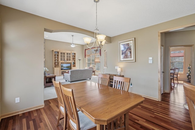 2011 117th Ln NE, Blaine, MN 55449 - dining room with wood finished floors, a chandelier, ceiling fan, and arched walkways