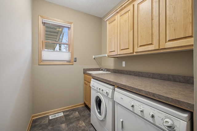 2011 117th Ln NE, Blaine, MN 55449 - laundry area featuring separate washer and dryer, cabinet space, and a textured ceiling