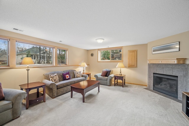 2011 117th Ln NE, Blaine, MN 55449 - living area with light carpet, a tile fireplace, and a textured ceiling