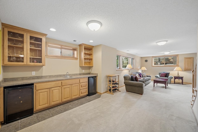 2011 117th Ln NE, Blaine, MN 55449 - kitchen featuring wine cooler, refrigerator, carpet, open floor plan, and glass insert cabinets