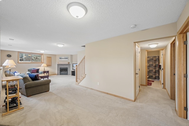 2011 117th Ln NE, Blaine, MN 55449 - living room featuring light carpet, a textured ceiling, a fireplace, and stairway