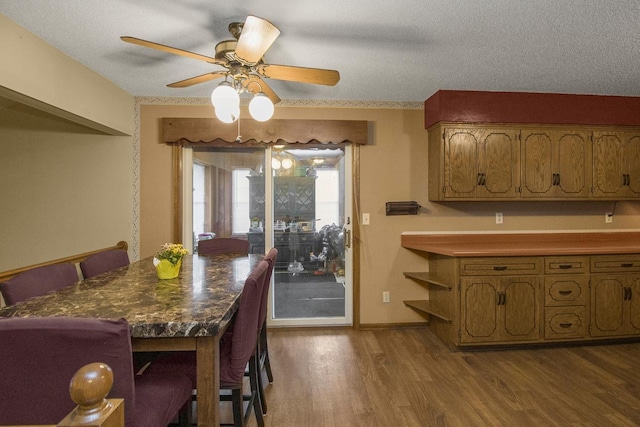 2246 Vivian Ln, Saint Paul, MN 55119 - dining area featuring dark wood finished floors, a ceiling fan, and a textured ceiling