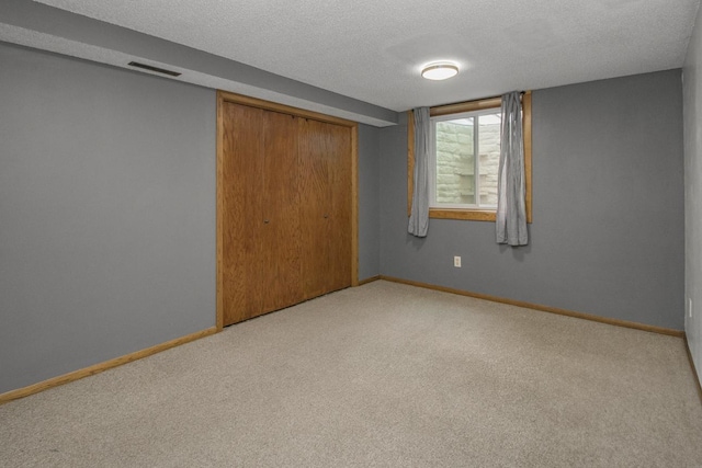 2246 Vivian Ln, Saint Paul, MN 55119 - unfurnished bedroom with carpet, a closet, and a textured ceiling