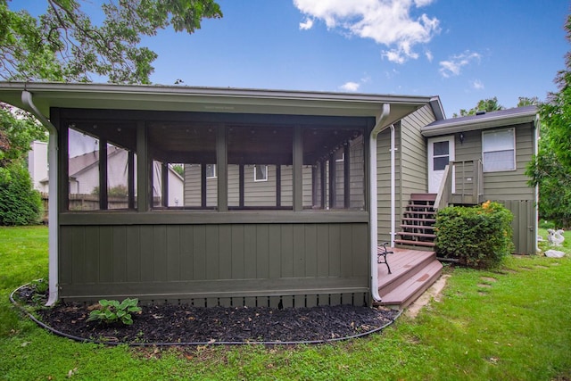 2246 Vivian Ln, Saint Paul, MN 55119 - back of house with a sunroom, a yard, and stairway