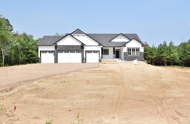 21207 Tippecanoe St NE, East Bethel, MN 55011 - modern farmhouse with stone siding, driveway, an attached garage, and roof with shingles