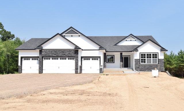 21207 Tippecanoe St NE, East Bethel, MN 55011 - view of front of home with stone siding, dirt driveway, an attached garage, roof with shingles, and a porch