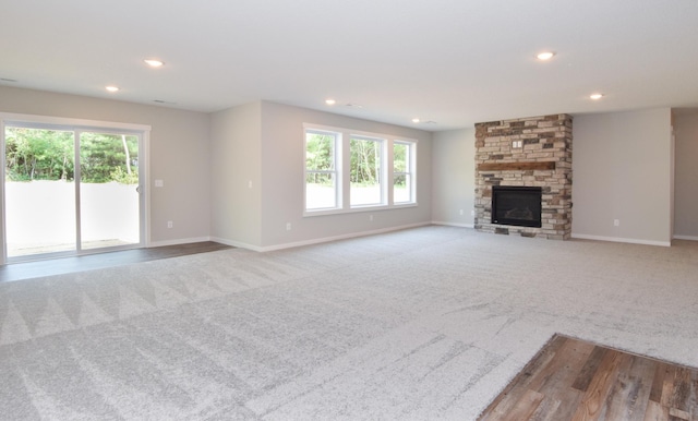 21207 Tippecanoe St NE, East Bethel, MN 55011 - unfurnished living room featuring carpet, recessed lighting, and a stone fireplace