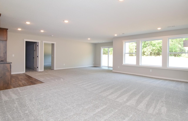21207 Tippecanoe St NE, East Bethel, MN 55011 - unfurnished living room featuring light colored carpet and recessed lighting