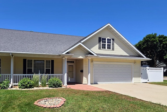 301 6th St SW, Pipestone, MN 56164 - traditional-style home featuring concrete driveway, covered porch, and a garage