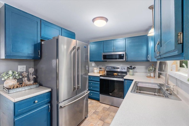 1145 Norton St, Hammond, WI 54015 - kitchen featuring stainless steel appliances, blue cabinetry, light countertops, and stone finish floors