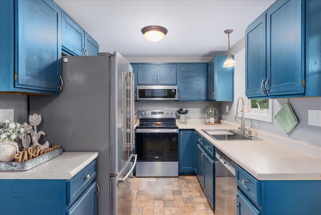 1145 Norton St, Hammond, WI 54015 - kitchen featuring appliances with stainless steel finishes, blue cabinetry, stone finish flooring, light countertops, and hanging light fixtures