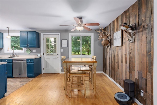 1145 Norton St, Hammond, WI 54015 - dining area with light wood-style flooring, a ceiling fan, and wood walls