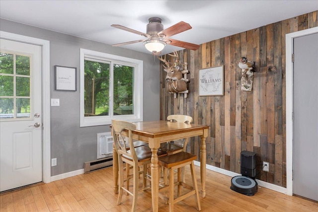 1145 Norton St, Hammond, WI 54015 - dining area with wooden walls, light wood finished floors, ceiling fan, and a baseboard radiator