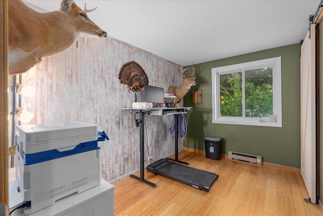 1145 Norton St, Hammond, WI 54015 - exercise area featuring a baseboard radiator, a barn door, and wood finished floors