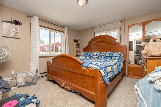 33406 151st Ave, Montgomery, MN 56069 - carpeted bedroom featuring multiple windows and a baseboard radiator