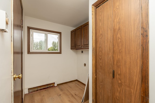 33406 151st Ave, Montgomery, MN 56069 - laundry room featuring cabinet space, a baseboard radiator, light wood-type flooring, and electric dryer hookup