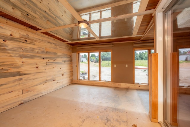 33406 151st Ave, Montgomery, MN 56069 - unfurnished room featuring unfinished concrete flooring, wooden walls, healthy amount of natural light, and wooden ceiling